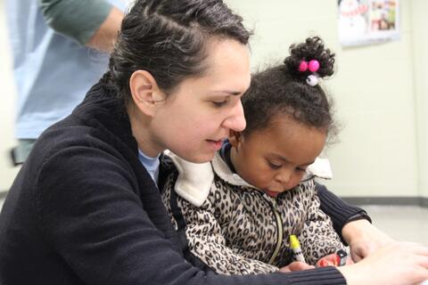 CC member Liat Kriegel with a young artist at the community mural event, Wilson Library in New Haven